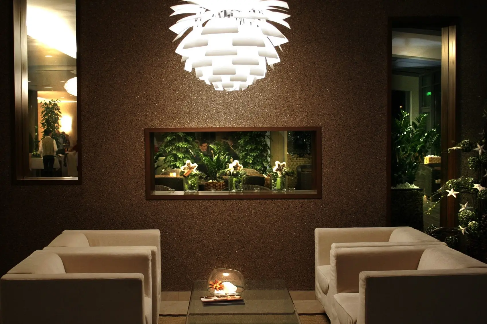 Seating area at Hotel Ponteo**** Rusovce with light upholstery and a brown textured wall