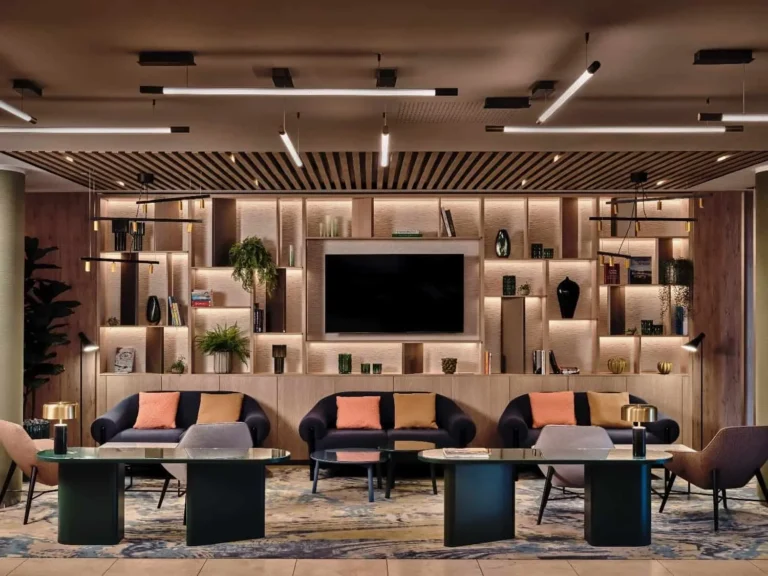 Lobby hotela Crowne Plaza Bratislava s tmavými pohovkami, farebnými vankúšmi a vzorovaným kobercom